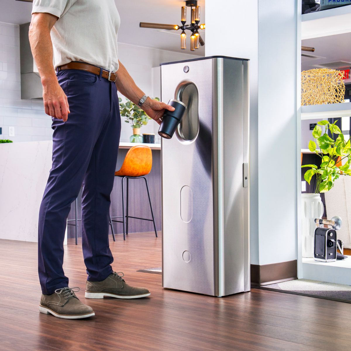 Man filling bottle from Kara Pure 2 dispenser