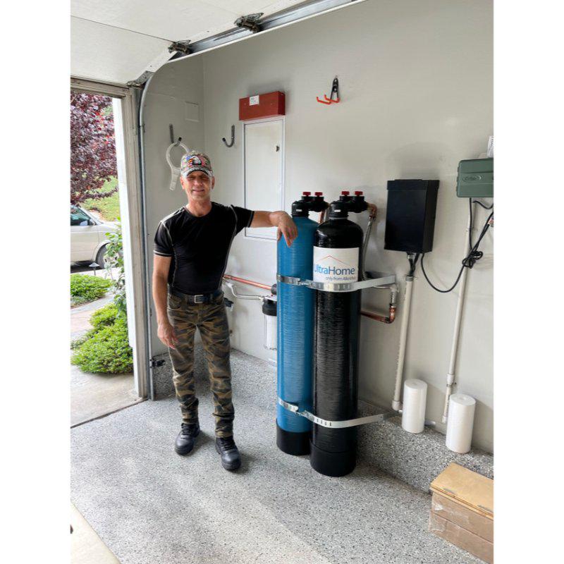 UltraWater UltraHome Premium + Salt-Free Softener Combo man with the system